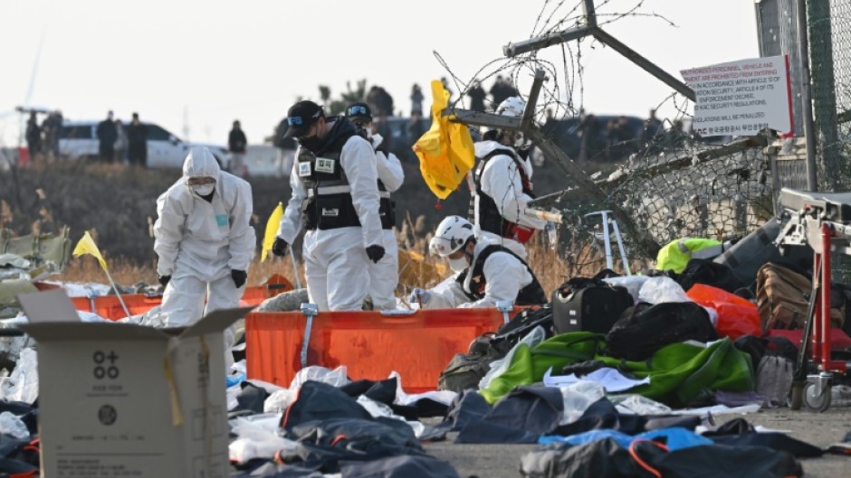 Firefighters and rescue personnel working after the Jeji Air crash