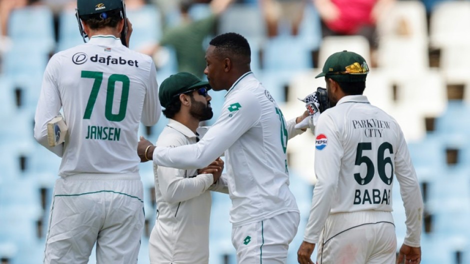 Pakistan's Mohammad Rizwan (CL) congratulates South Africa's Kagiso Rabada (CR) after he steered the hosts to victory in a nailbiting climax to the first Test