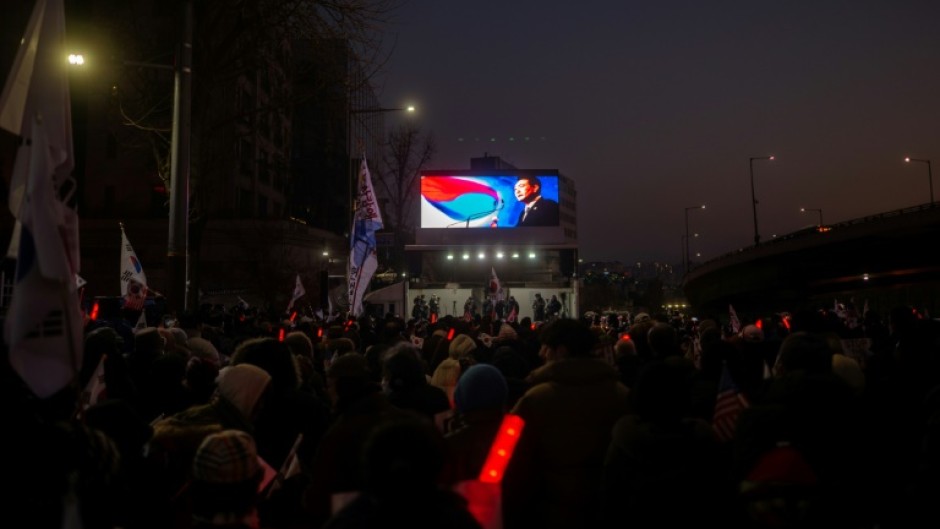 A portrait of impeached South Korean President Yoon Suk Yeol is seen at a rally to support him