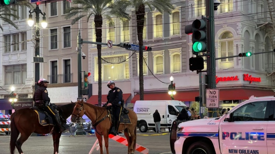 Police cordon off the intersection of Canal Street and Bourbon Street in the French Quarter of New Orleans, Louisiana after a driver rammed a truck into a crowd, killing at least 10.