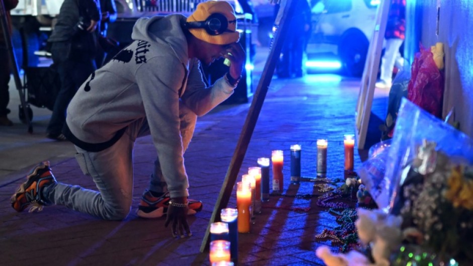 A mourner reacts at a memorial on New Orlean's Bourbon Street on January 2, 2025 one day after a man drove a truck into the crowded street, killing 14 people