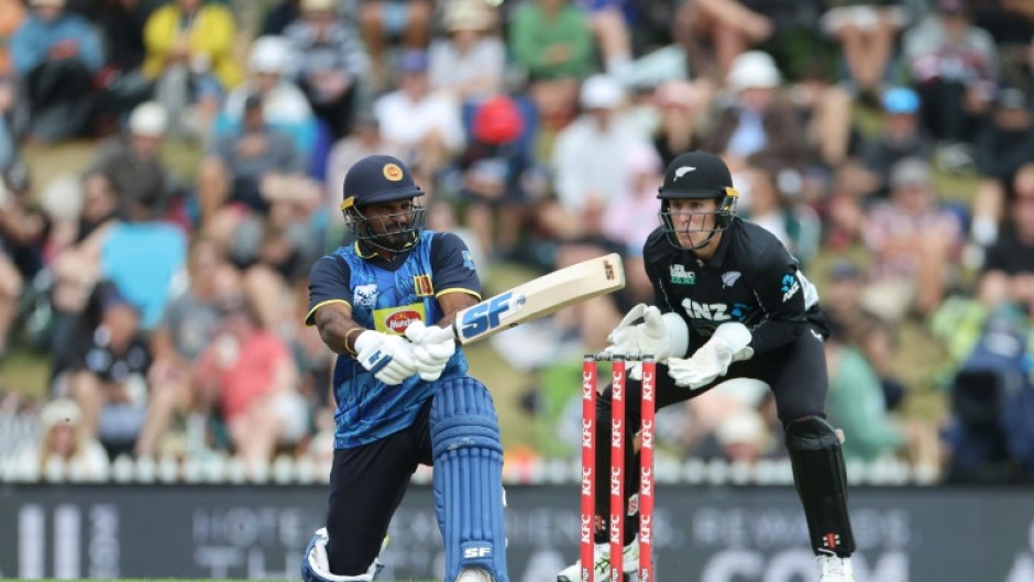 Sri Lanka's Kusal Perera plays a shot as New Zealand wicketkeeper Mitch Hay looks on during the third Twenty20