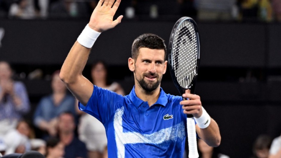 Novak Djokovic celebrates defeating Gael Monfils in Brisbane