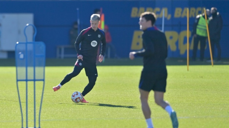 Barcelona midfielder Dani Olmo (L) is in an uncertain situation with the club not yet registering him