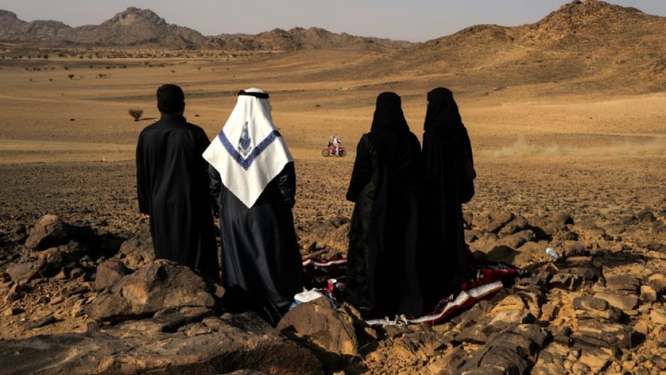 Local residents watch as cars, motorbikes and truck drivers got their 2025 Dakar Rally campaign underway in Bisha, Saudi Arabia 