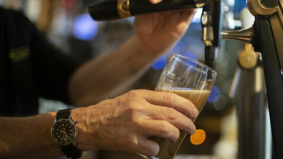 A bartender pours a draft beer in a bar in Brest, western France