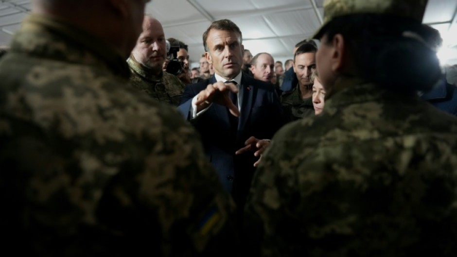 French President Emmanuel Macron speaks with Ukrainian soldiers during a visit to a military camp in eastern France in October, 2024