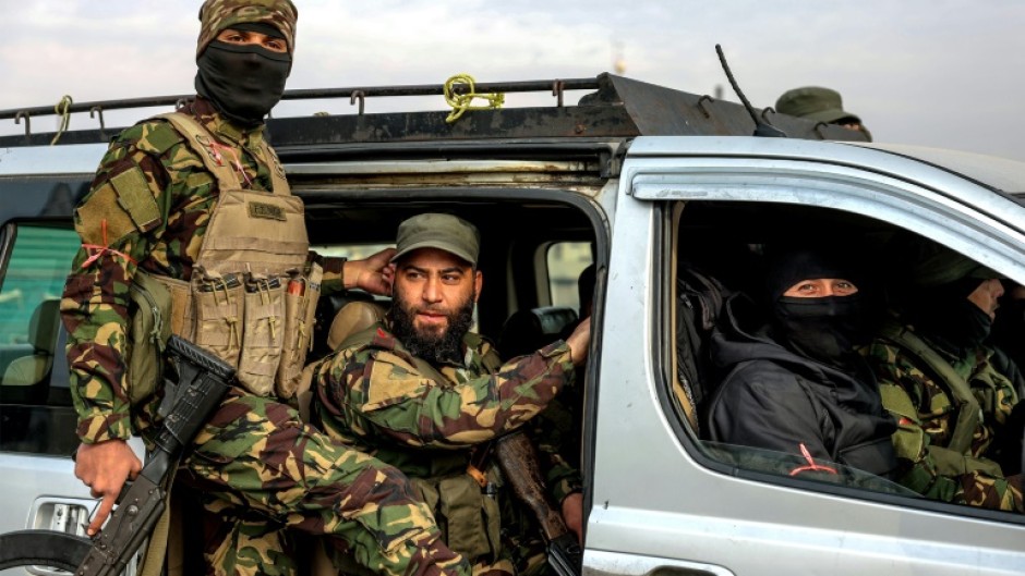 Fighters loyal to the interim Syrian government, in the Zahra district of Homs