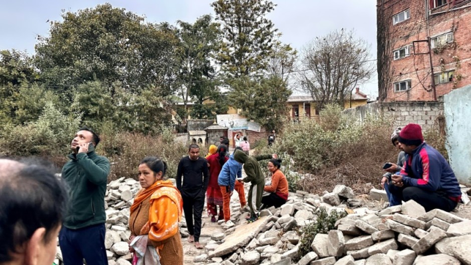 People gather in an open area of Nepal's capital Kathmandu after feeling the powerful tremor in neighbouring Tibet