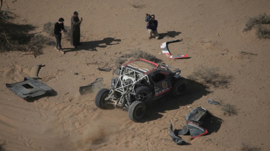 Sebastien Loeb starts rolling again after patching up his car following a crash on stage three of the Dakar Rally