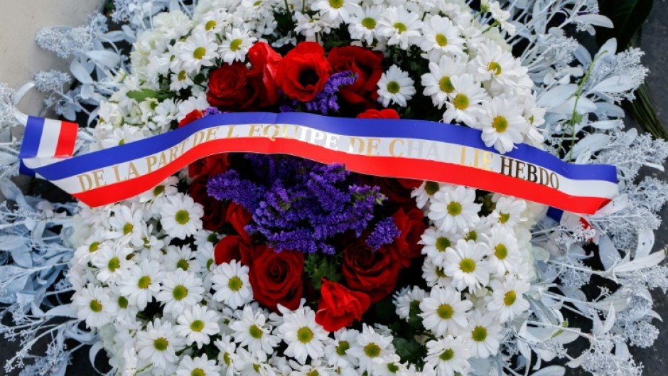 French President Emmanuel Macron and Paris Mayor Anne Hidalgo both laid wreaths near the publication's former offices