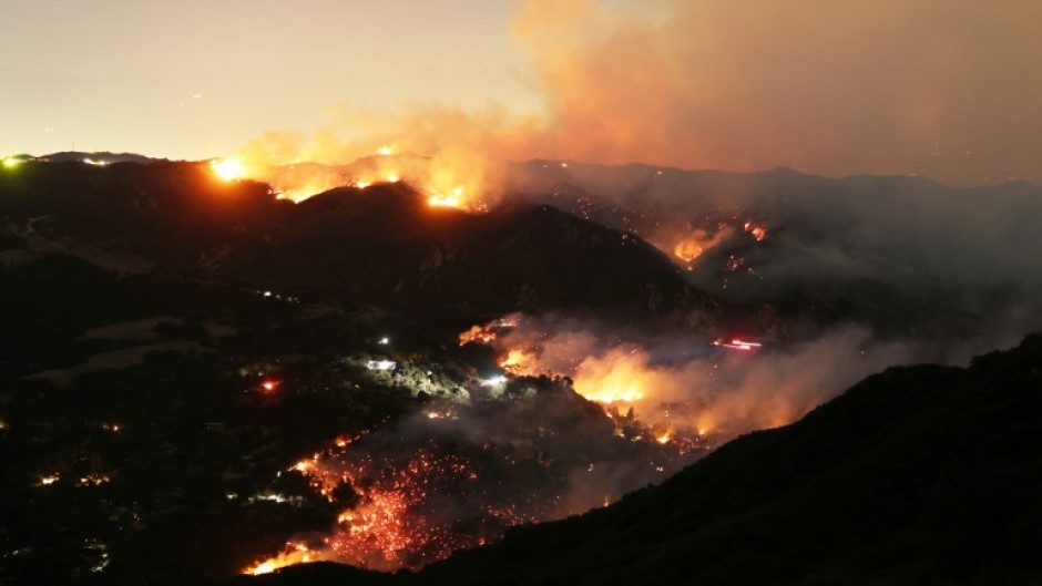 Flames and smoke from the Palisades Fire engulf parts of the community of Topanga, California