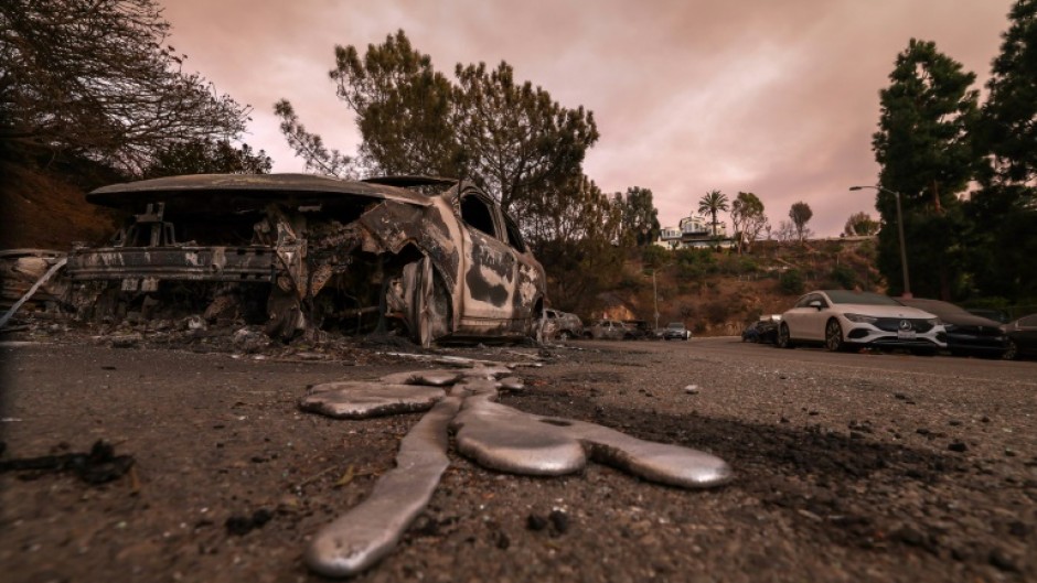 Molten metal flows from a car burnt out by the Palisades Fire in Los Angeles, California 