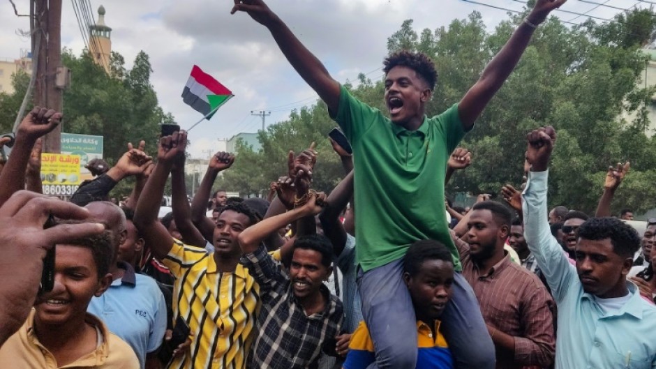 People in Sudan's de facto capital Port Sudan, which hosts the army-aligned government, take to the streets to celebrate the reported advance of Sudanese military forces and allied armed groups on the key Al-Jazira state capital, Wad Madani