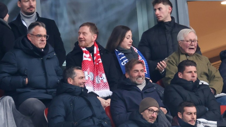 Jurgen Klopp (2ndR C) sits next to former Germany forward Mario Gomez (R) in RB Leipzig's 4-2 win over Werder Bremen