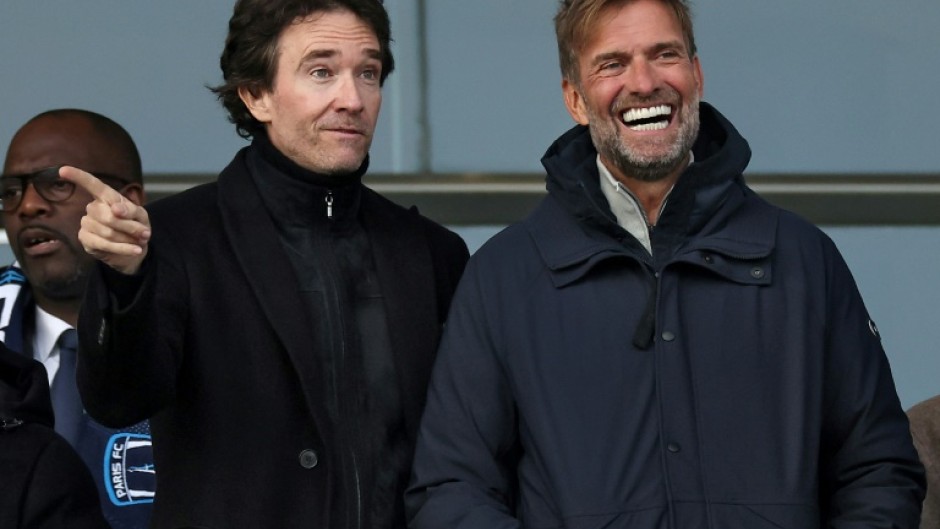 German football coach Jurgen Klopp (R) and Antoine Arnault (L) whose family have purchased a stake in French Ligue 2 club Paris FC before a match on Saturday