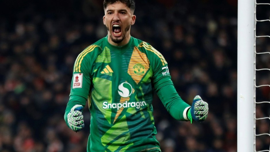 Manchester United goalkeeper Altay Bayindir celebrates after saving Kai Havertz's penalty