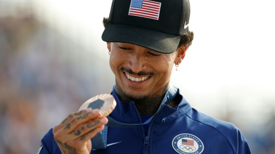 Nyjah Huston holds his bronze medal after the victory ceremony for the men's street skateboarding event on July 29, 2024