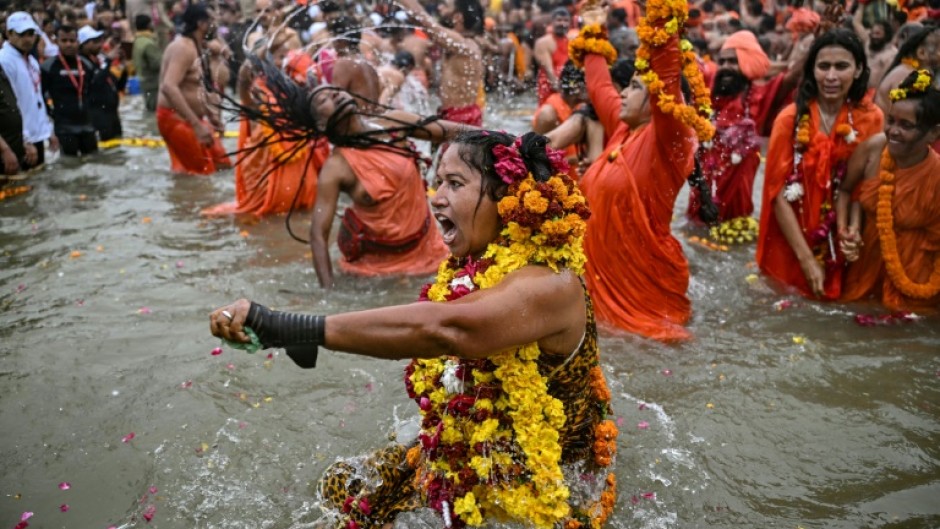 Sadhvis or Hindu holy women take part in a mass bathing ritual in Sangam