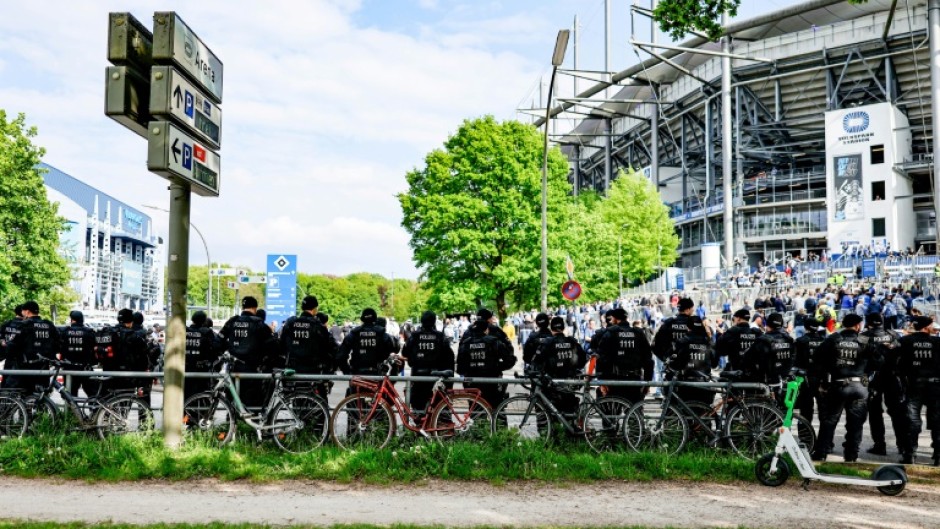 Police forces stand guard outside the Volksparkstadion in Hamburg. 