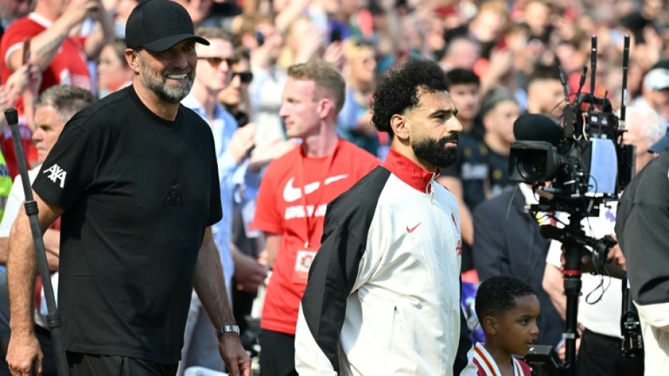 Jurgen Klopp walks out with Mohamed Salah before the German's final match in charge of Liverpool last May