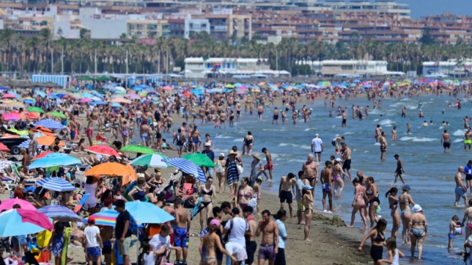 People crowd the beach in Valencia on July 5, 2024