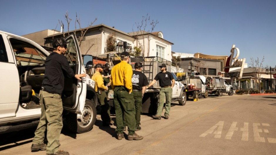 Private firefighters stand watch at property opwned by billionaire developer Rick Caruso