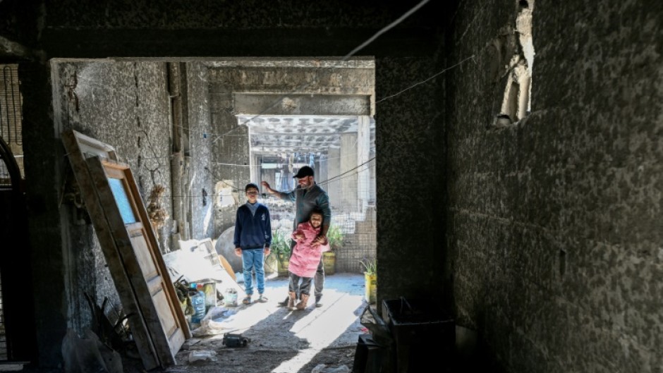 Ahmad Kafozi and his children are staying with relatives because their home is too badly damaged