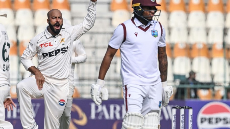 Pakistan's Sajid Khan celebrates after taking the wicket of West Indies' Keacy Carty (R) during the second day of the first Test at Multan