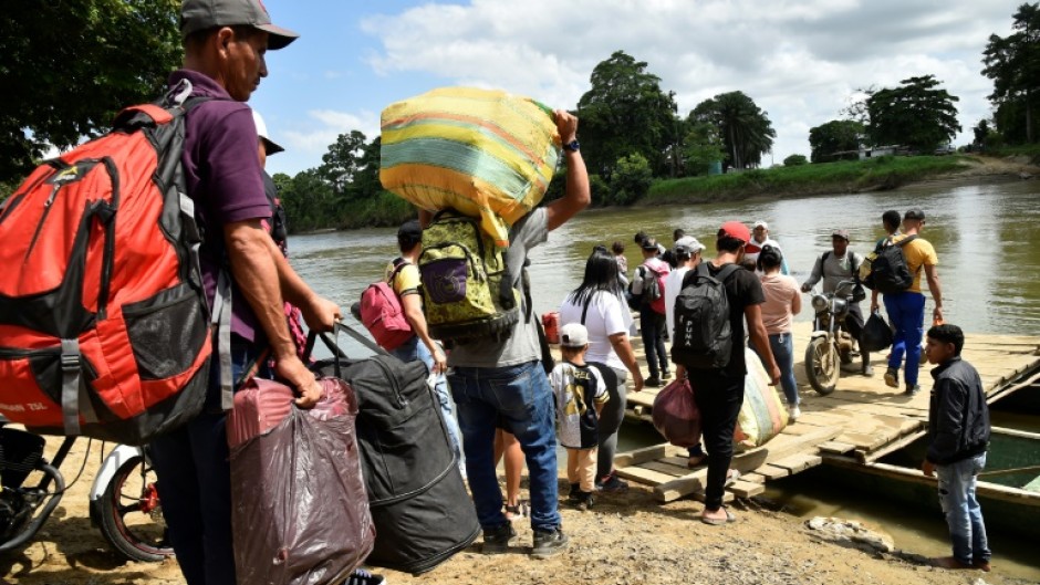 Displaced people from recent clashes between armed groups cross the Tarra River, which divides Colombia and Venezuela, in Tibu, Colombia on January 19, 2025