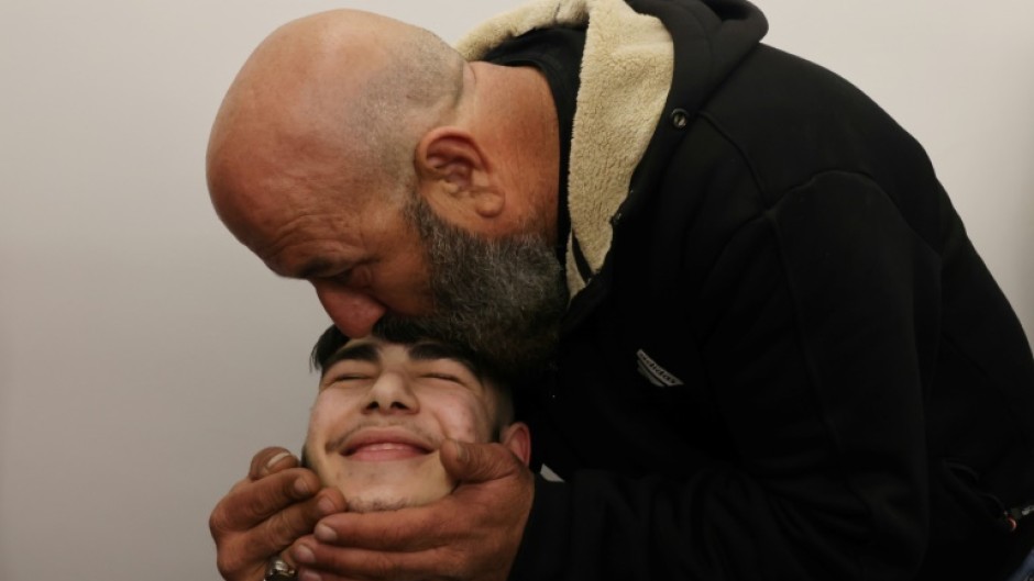 The uncle of 17-year-old Palestinian prisoner Qassem Jaafra kisses his forehead upon his arrival home in east Jerusalem 