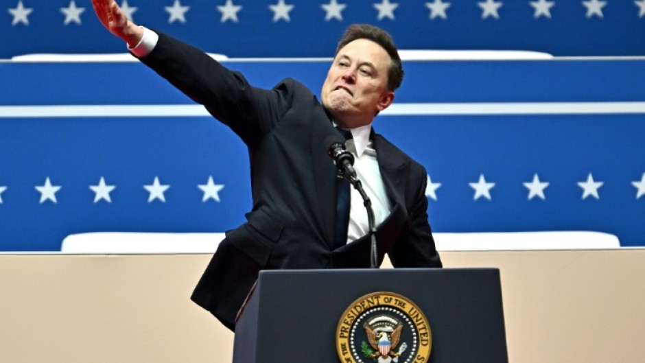 Tesla and SpaceX CEO Elon Musk gestures as he speaks during a post-inauguration celebration in Washington