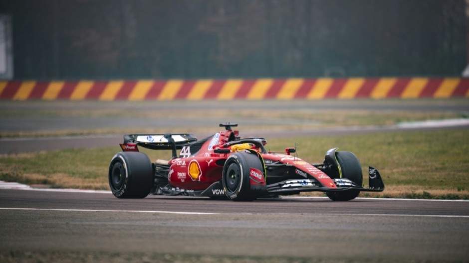 First time: This handout picture released by Ferrari shows Lewis Hamilton testing the Ferrari F1SF 75 on the Fiorano circuit