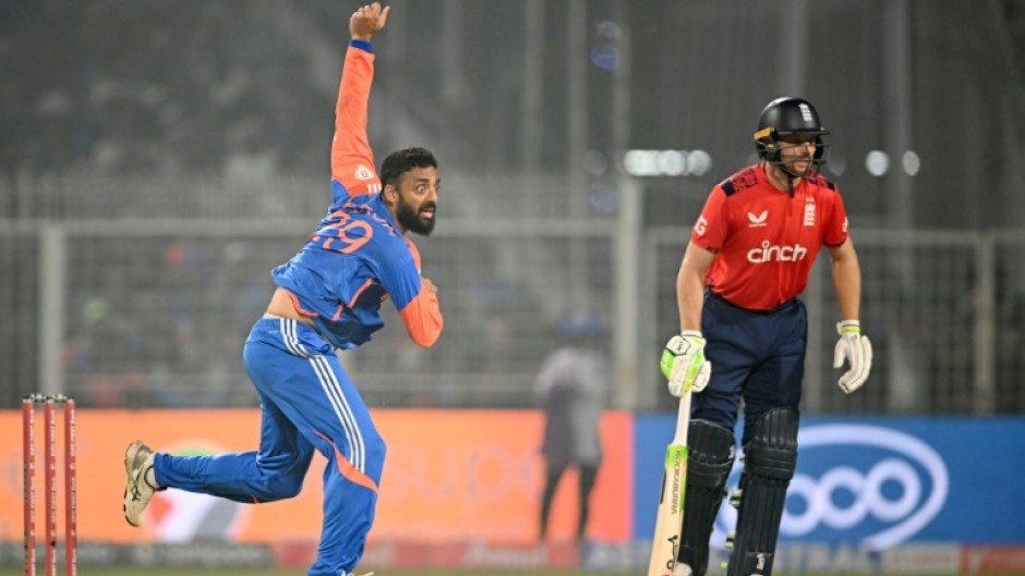 India's Varun Chakravarthy (L) took three wickets, including the crucial scalp of Jos Buttler (R)