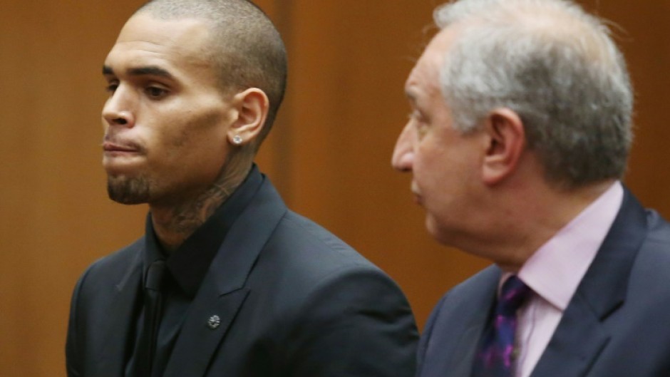 Chris Brown, pictured in court in 2013, has filed a $500 million lawsuit against Warner Bros and others for making a 'defamatory documentary'