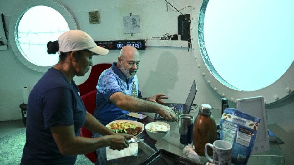 Rudiger Koch has breakfast in his underwater home before emerging as a world record holder