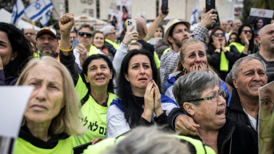 Relatives and friends of Israeli hostages watch the release of four women soldiers from captivity in Gaza, on a screen at 'Hostage Square' in Tel Aviv