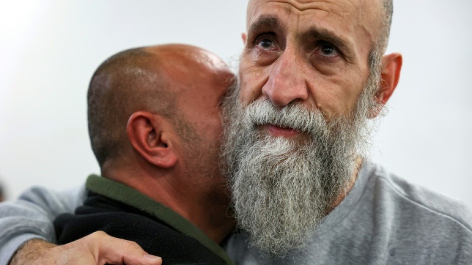 A well-wisher embraces freed prisoner Raed al-Saadi, 56, who spent 36 years behind bars.