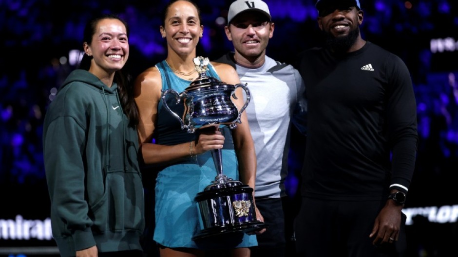 Madison Keys stands alongside husband and coach Bjorn Fratangelo with her team after lifting the Australian Open trophy