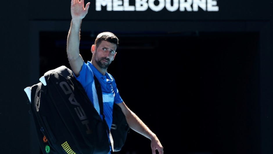 All over: Novak Djokovic exits the court after retiring from the Australian Open semi-final against Alexander Zverev