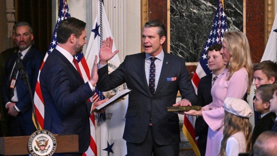 Pete Hegseth (C) -- surrounded by his wife and children -- is sworn in as the new US secretary of defense by Vice-President JD Vance (L)