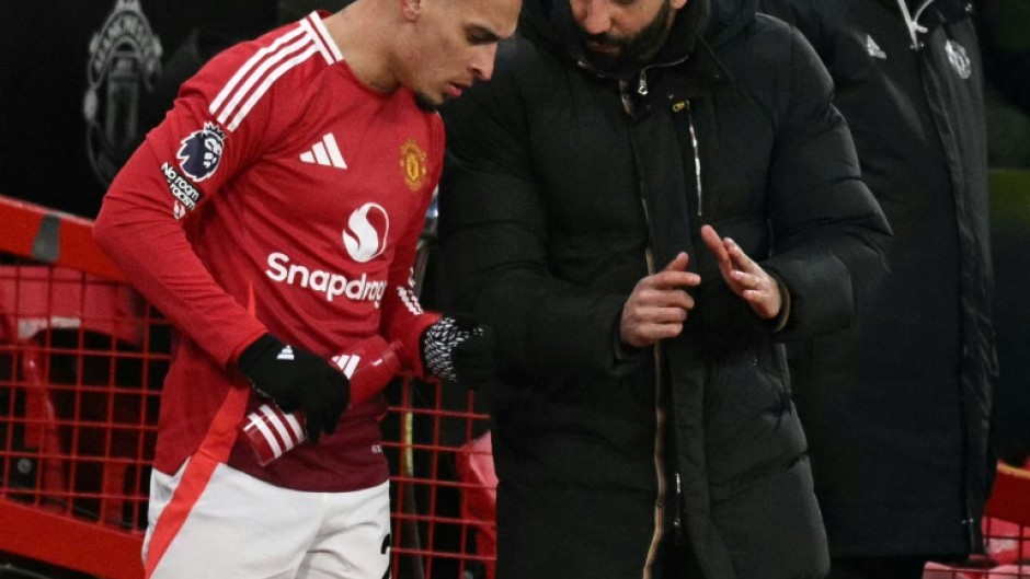 Manchester United's coach Ruben Amorim (R) pictured talking to Antony, who has joined Real Betis on loan