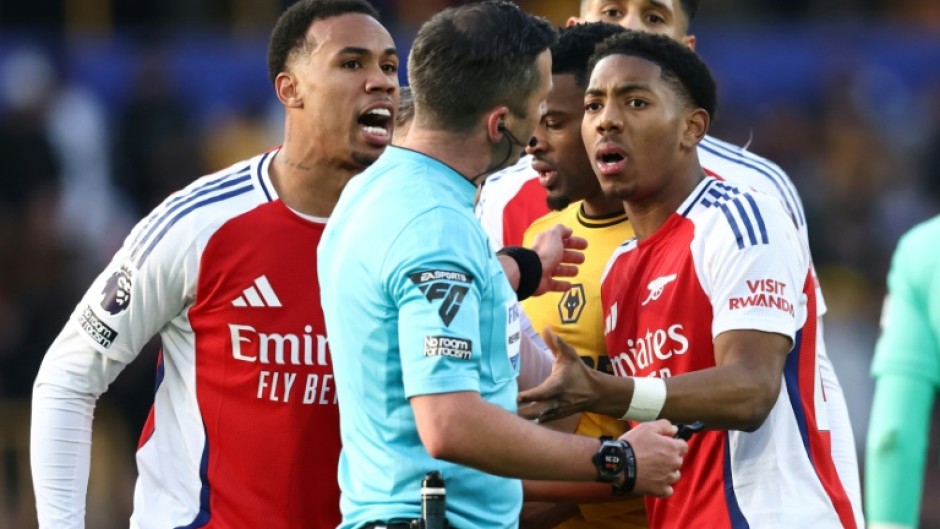 Arsenal's Myles Lewis-Skelly (R) reacts after being sent off at Wolves