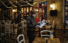 A waiter sanitises the menu of a restaurant at the Montecasino complex.