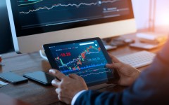 File: A businessman checking the stock market. Getty Images/ipopba