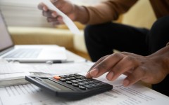 File: A man with a calculator checking bills.GettyImages/fizkes