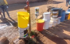 People queueing with buckets to get water. eNCA/Hloni Mtimkulu