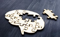 File: Brain from wooden puzzle pieces representing mental health and problems with memory. GettyImages/designer491