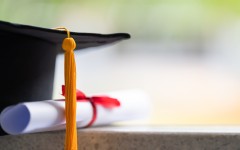 File: Close-up of a mortarboard and degree certificate. GettyImages/sengchoy