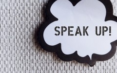 Word ballon on wallpaper with text SPEAK UP. GettyImages/ariya j